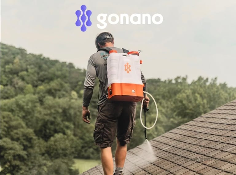 Person wearing Gonano orange and white delivery backpack standing on roof overlooking green forest landscape